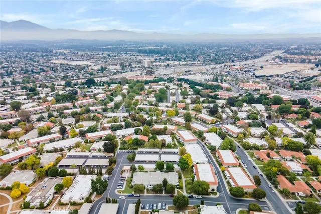 an aerial view of residential houses with city view