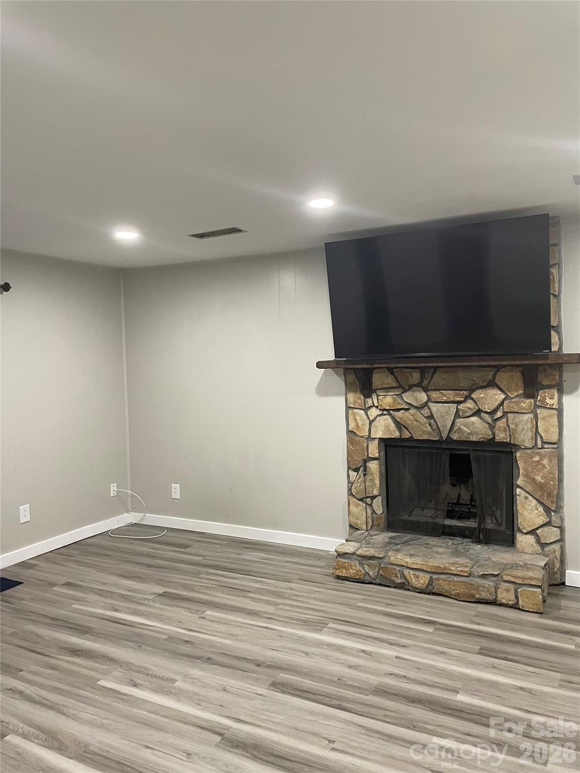 24016 Tidal Way Fort Mill, SC 29708 - Photo 3 of 9 a view of empty room with wooden floor and fireplace