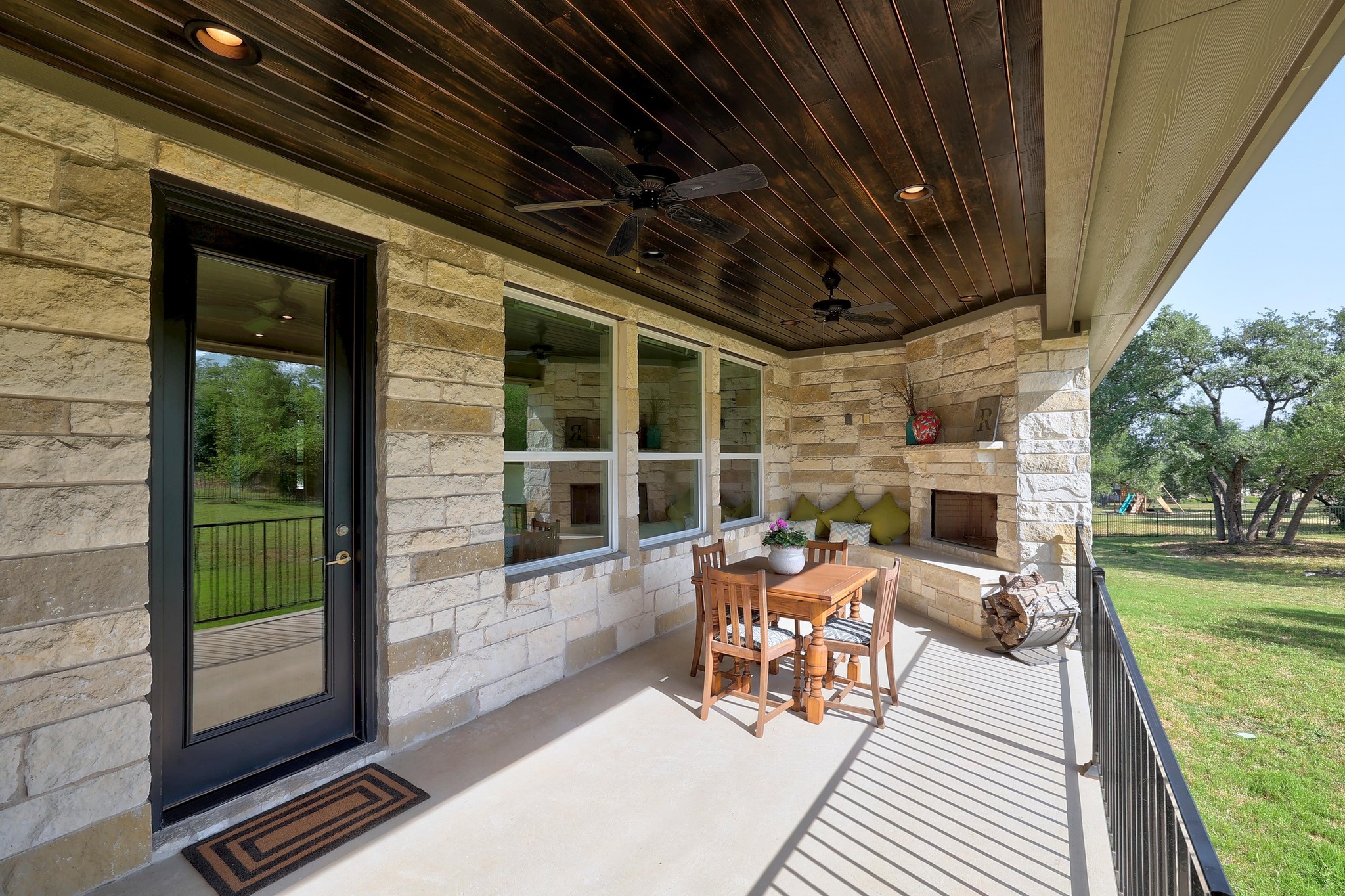105 Graystone Lane Georgetown, TX 78633 - Photo 28 of 32 View of patio featuring an outdoor stone fireplace and a ceiling fan