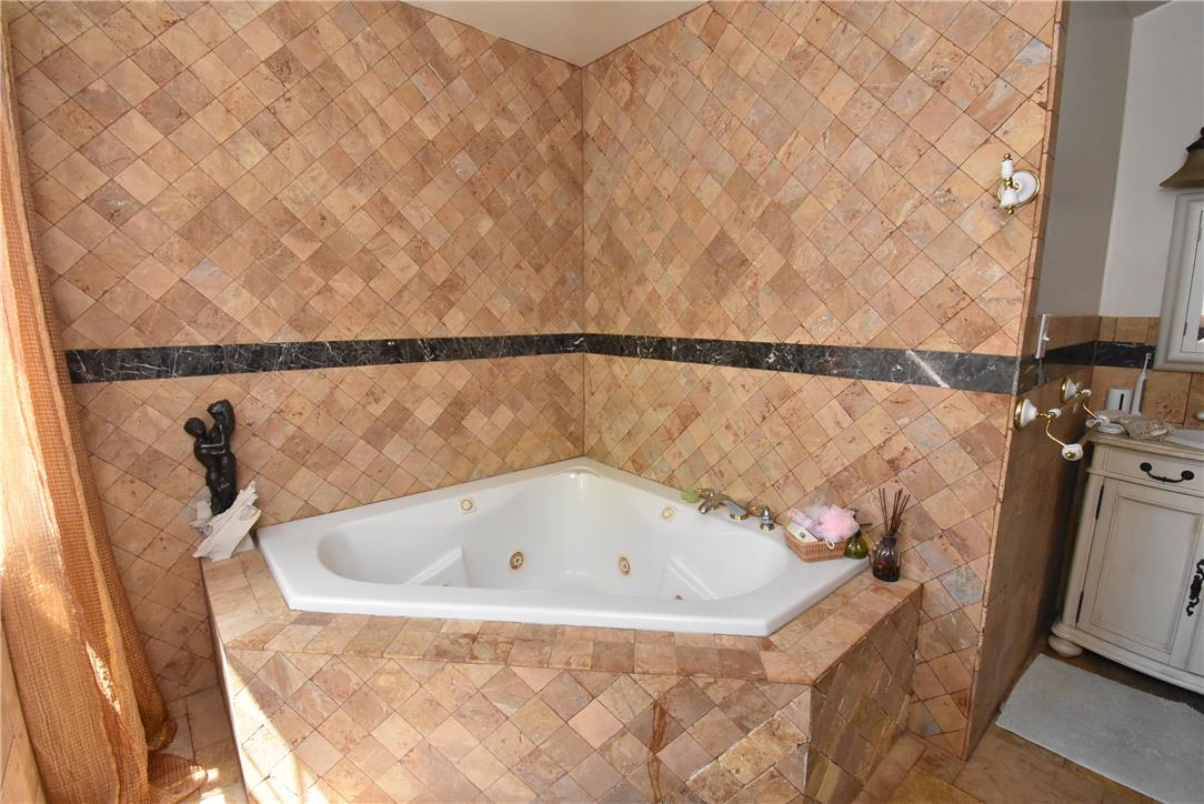 424 Grape Street Whitehall, PA 18052 - Photo 29 of 50 This primary bathroom offers a large jet soaking tub surrounded by elegant tile work.