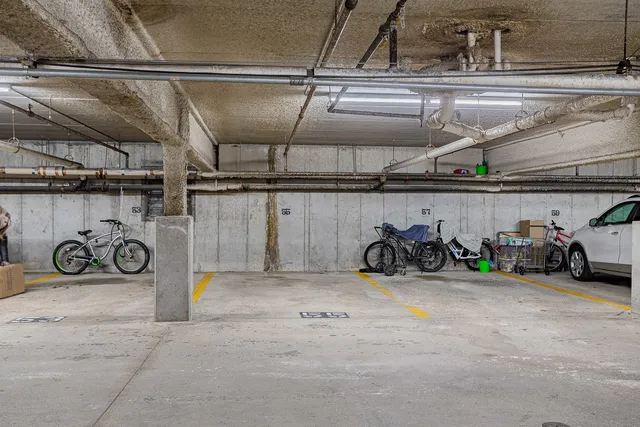 a view of parking garage with cars