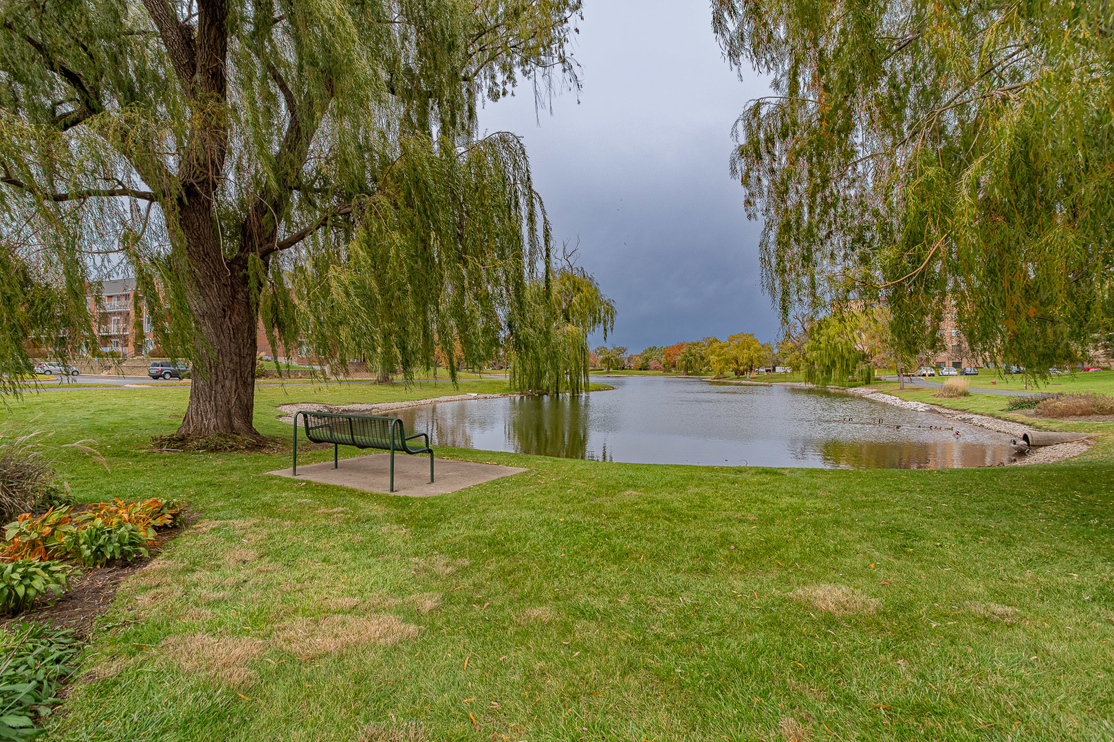 520 Biesterfield Road, Unit E220 Elk Grove Village, IL 60007 - Photo 21 of 21 a view of a yard with a bench