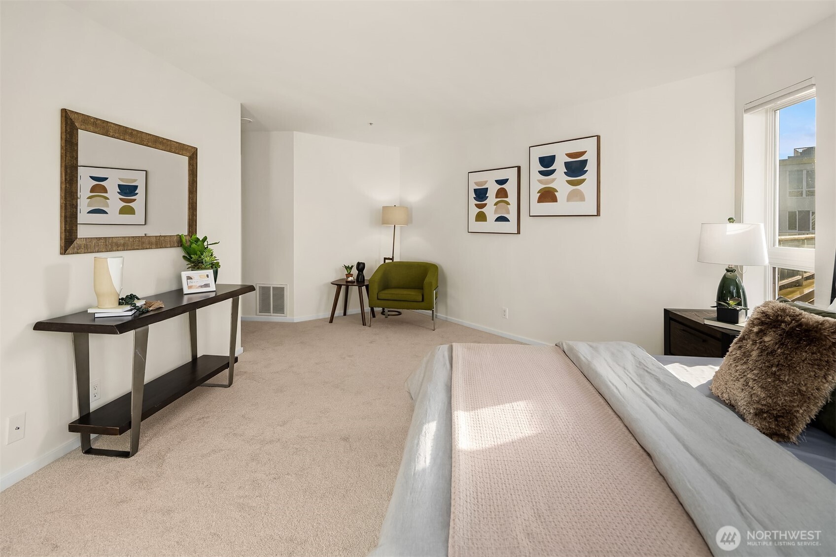 4528 8th Avenue Northeast, Unit 5A Seattle, WA 98105 - Photo 15 of 27 a bedroom with a bed and a chandelier