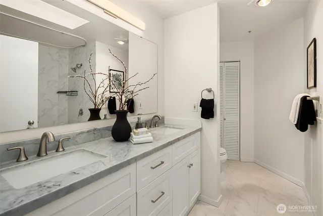 a bathroom with a double vanity sink and a mirror