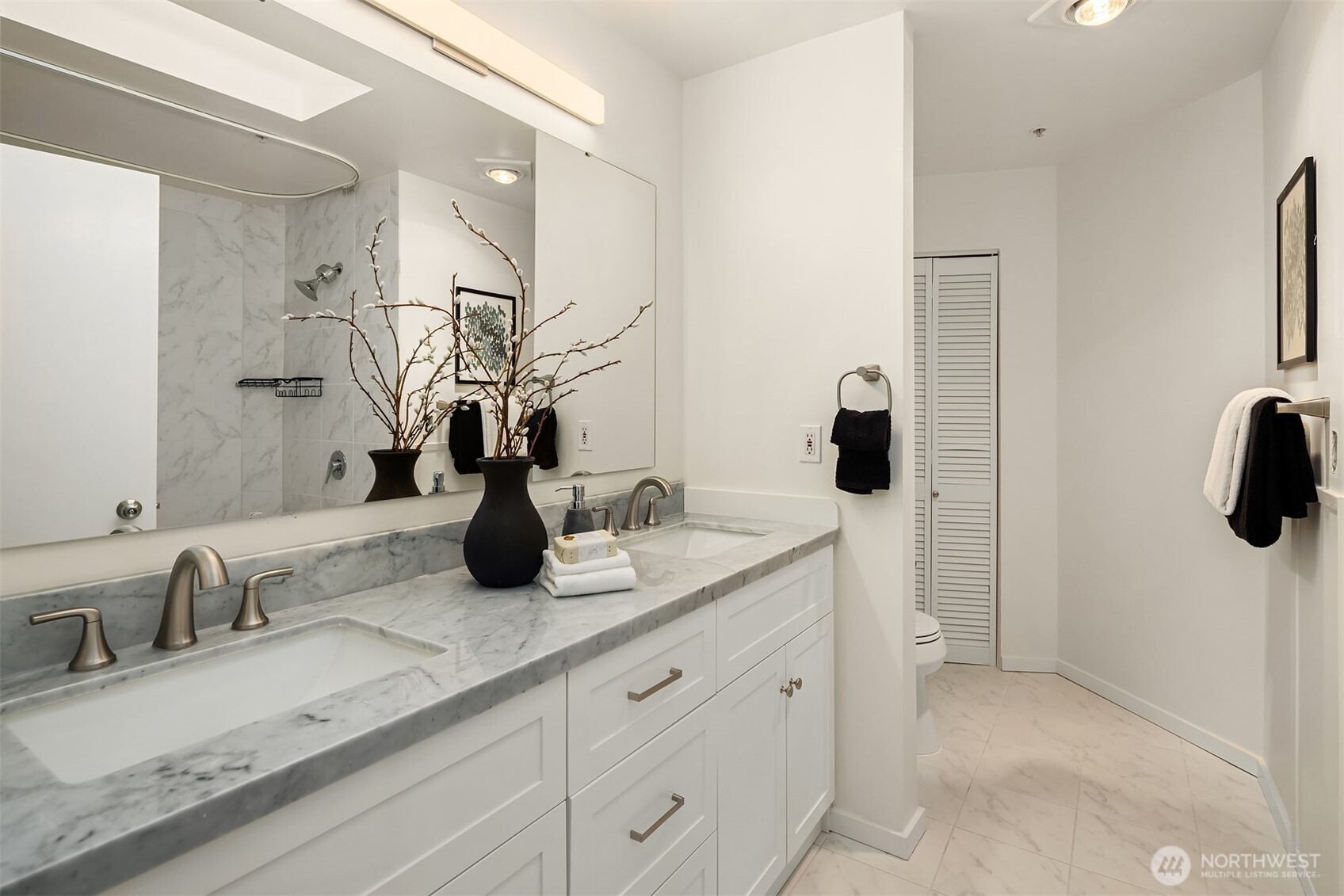 4528 8th Avenue Northeast, Unit 5A Seattle, WA 98105 - Photo 16 of 27 a bathroom with a double vanity sink and a mirror