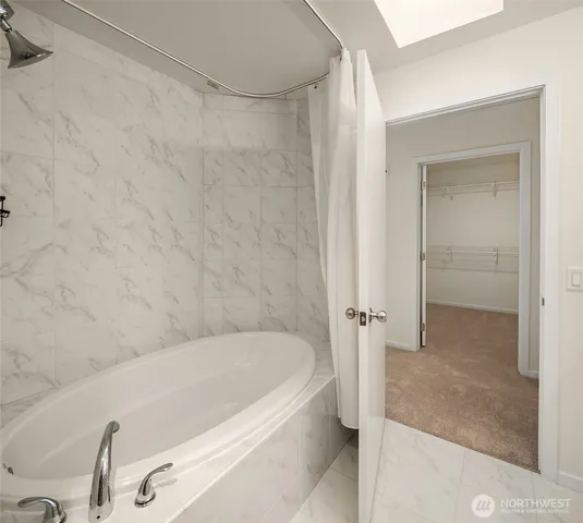 a bathroom with a tub and shower