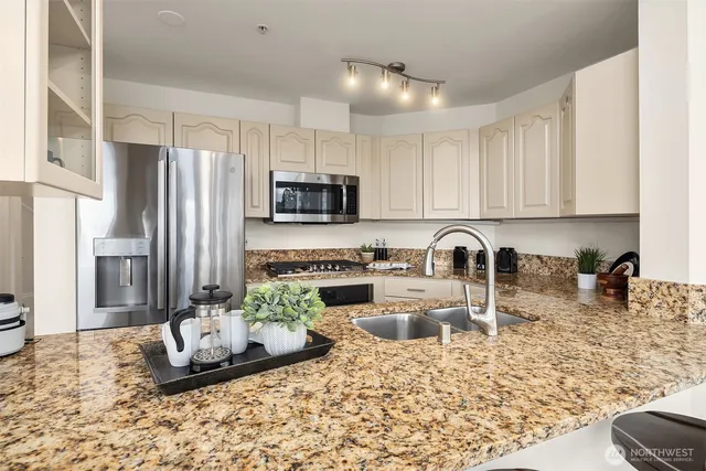 a kitchen with sink a stove and refrigerator