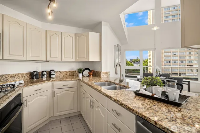 a kitchen with sink stove and cabinets