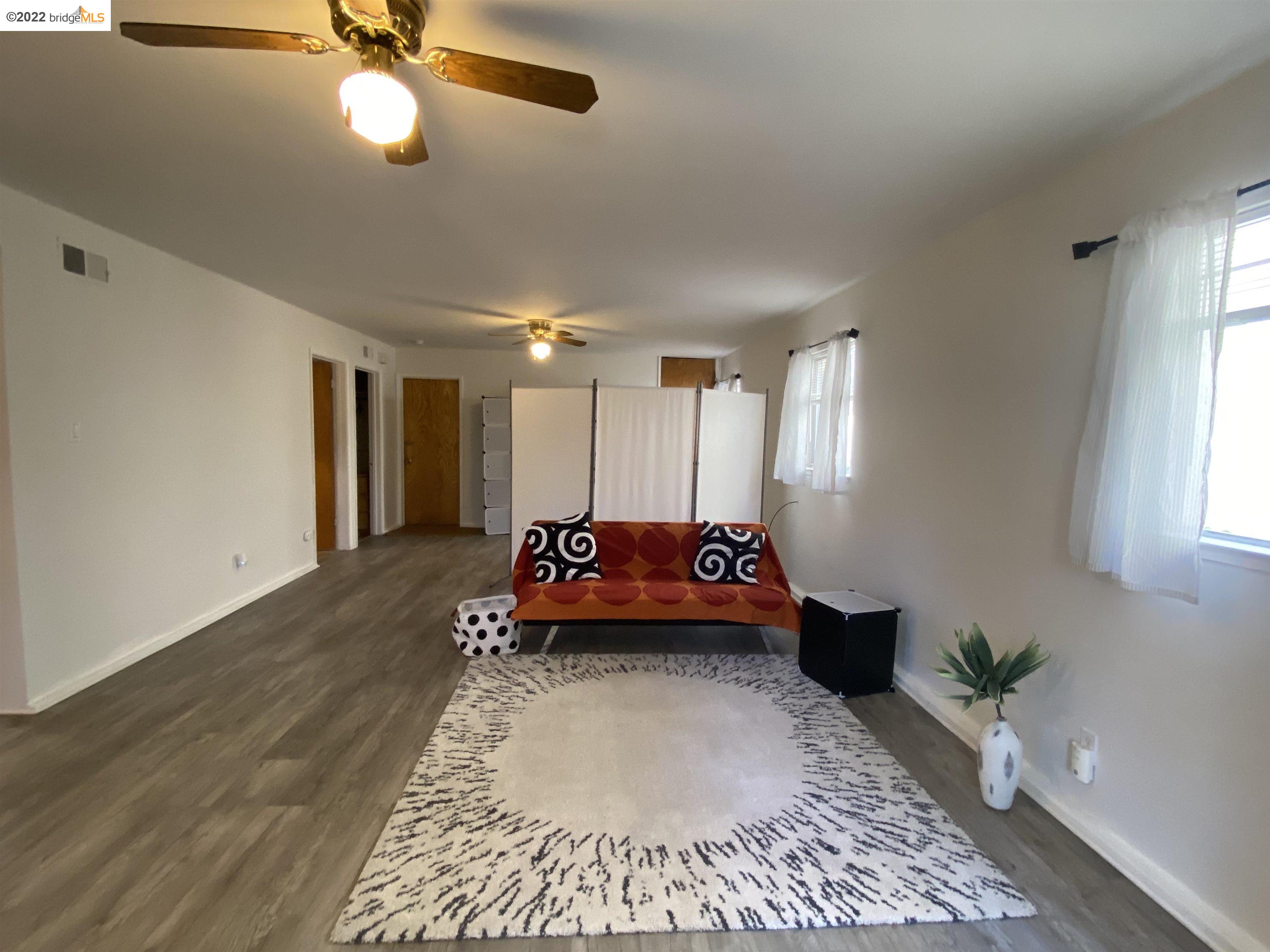 5357 Bryant Avenue Oakland, CA 94618 - Photo 11 of 26 a bed room with a bed and a chandelier