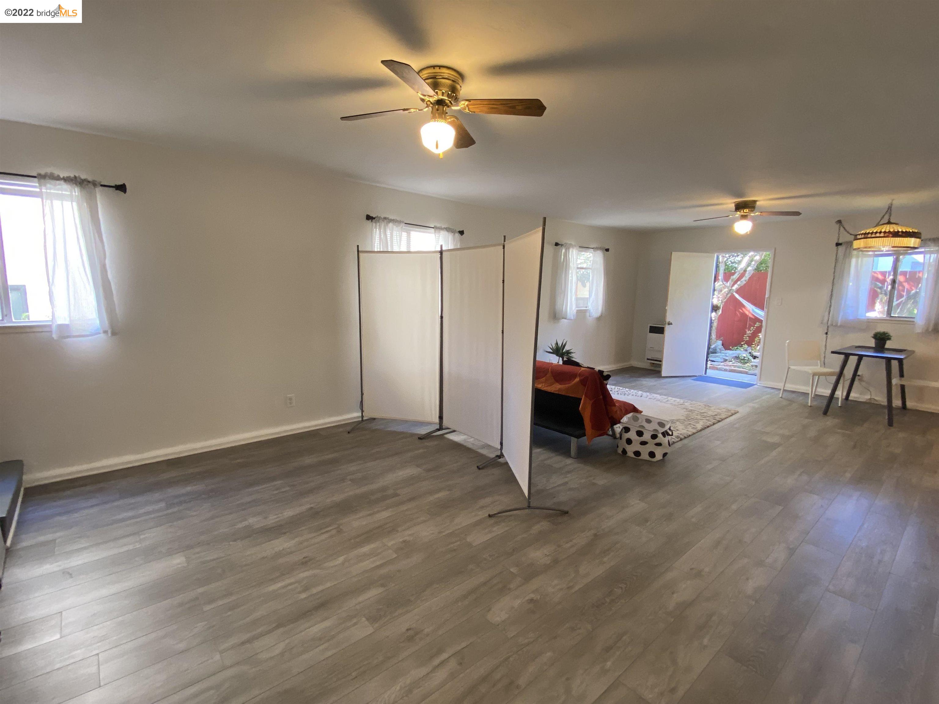 5357 Bryant Avenue Oakland, CA 94618 - Photo 13 of 26 a living room with furniture and a ceiling fan