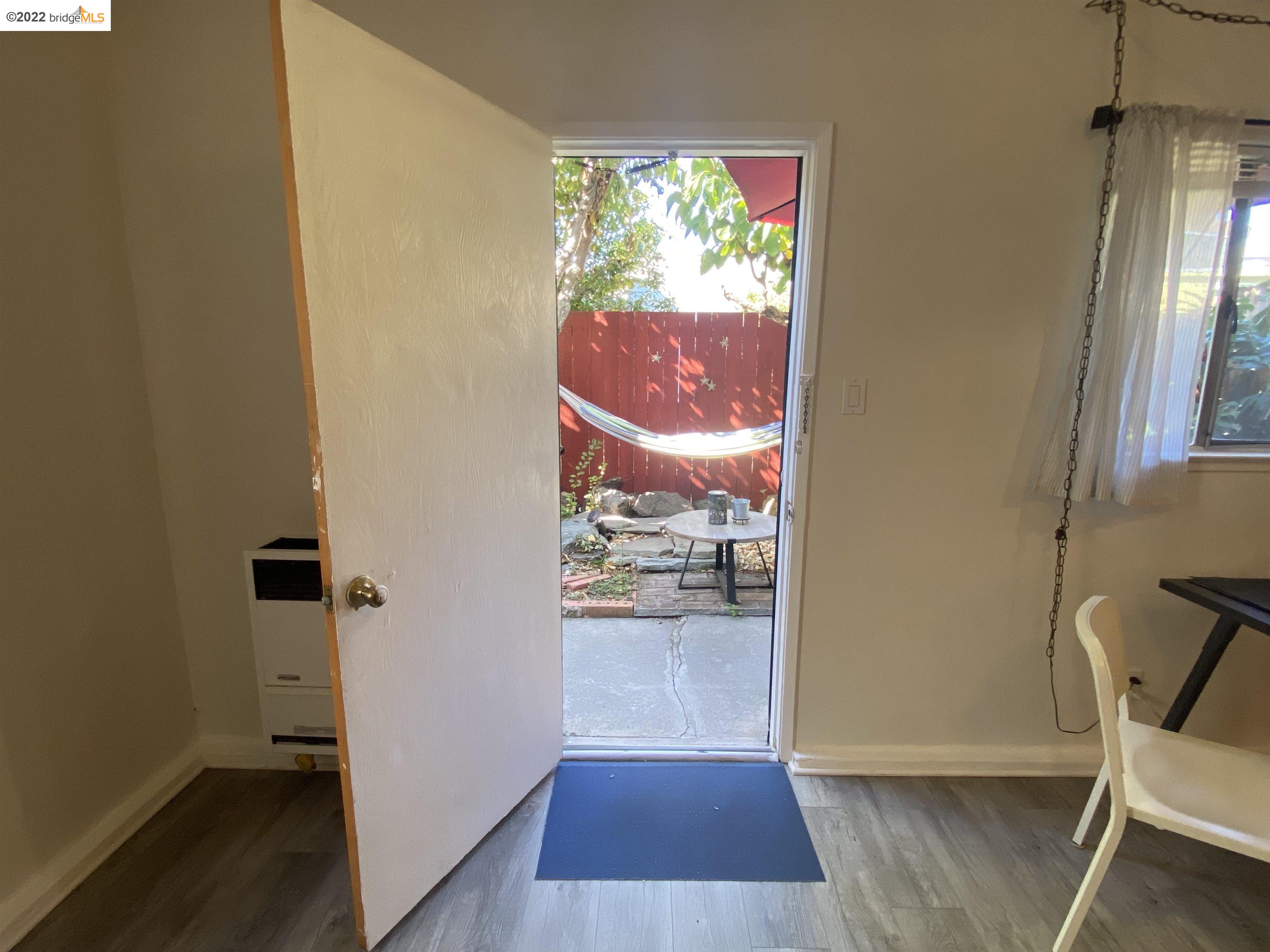 5357 Bryant Avenue Oakland, CA 94618 - Photo 19 of 26 an empty room with wooden floor and entrance