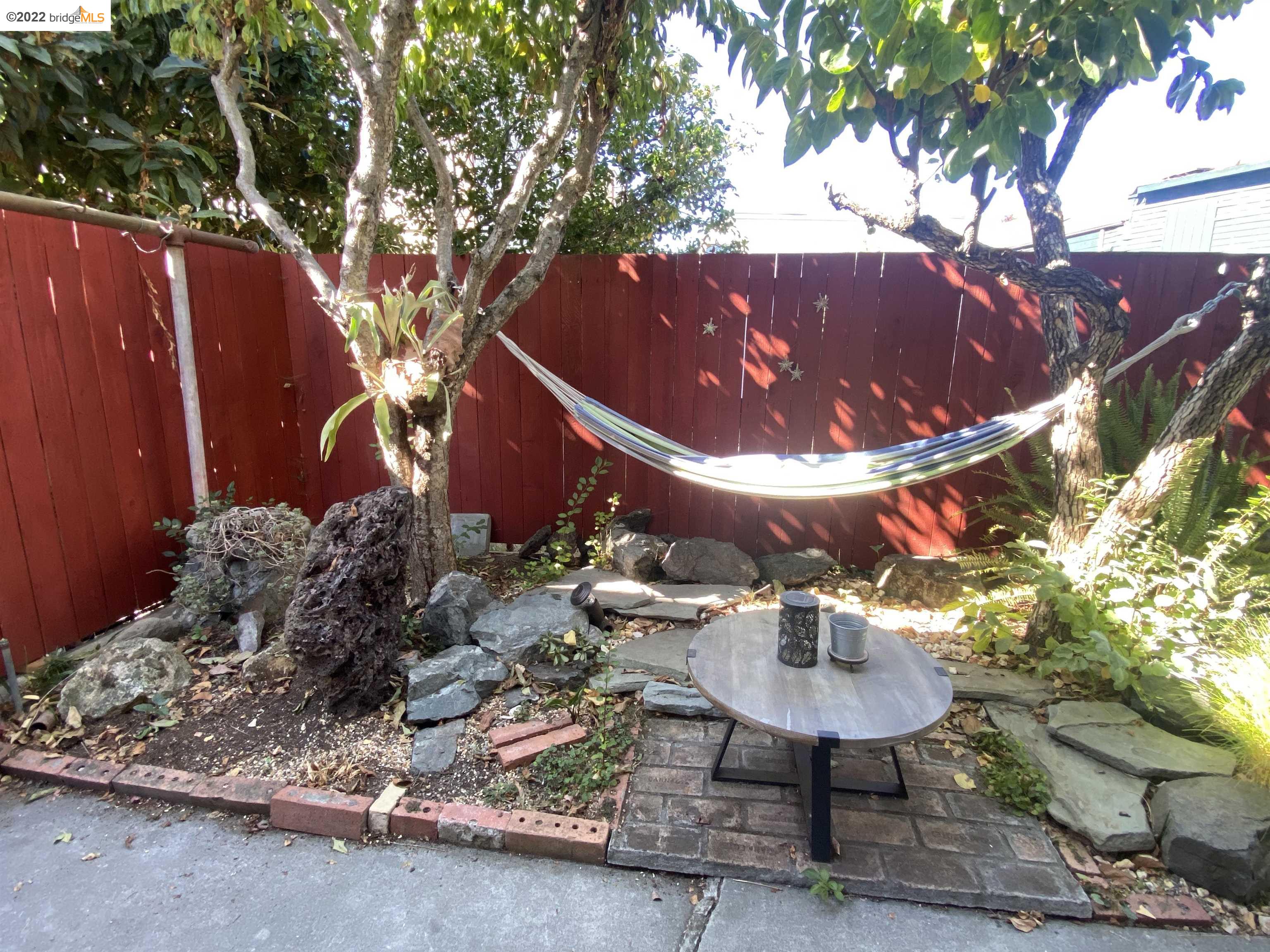 5357 Bryant Avenue Oakland, CA 94618 - Photo 20 of 26 a backyard of a house with table and chairs
