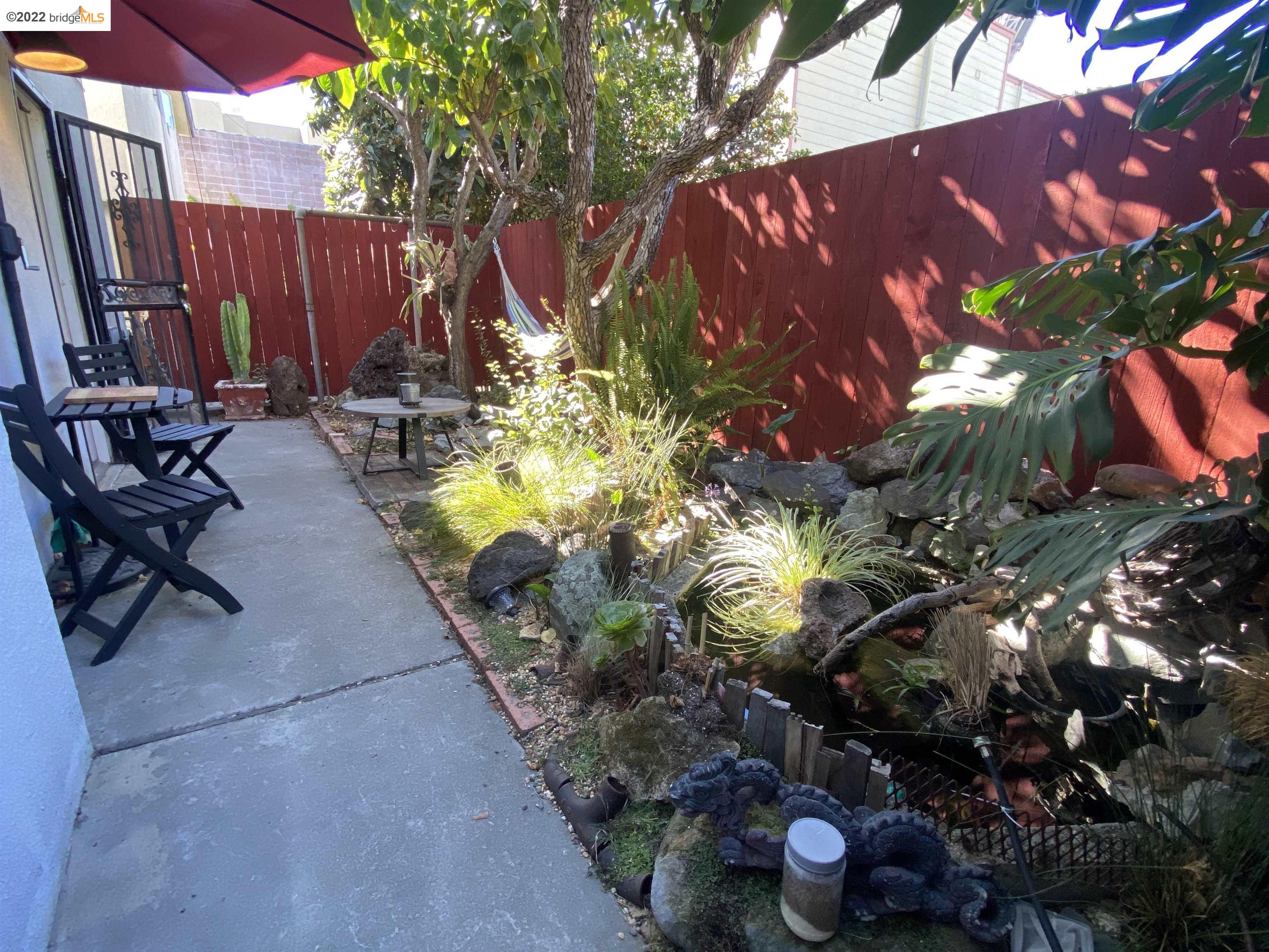 5357 Bryant Avenue Oakland, CA 94618 - Photo 22 of 26 a view of a backyard with plants and a patio