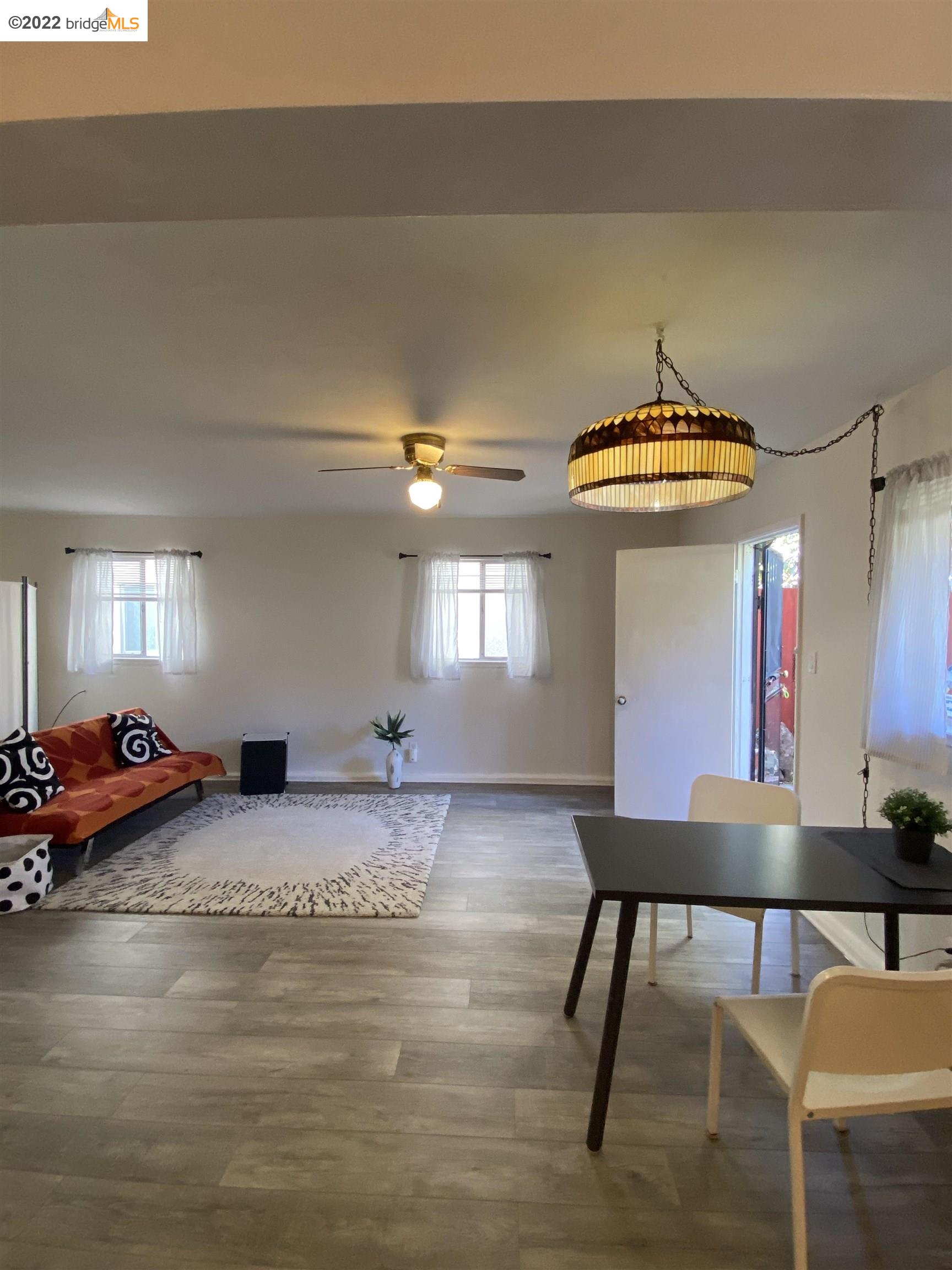 5357 Bryant Avenue Oakland, CA 94618 - Photo 3 of 26 a room with furniture and a chandelier