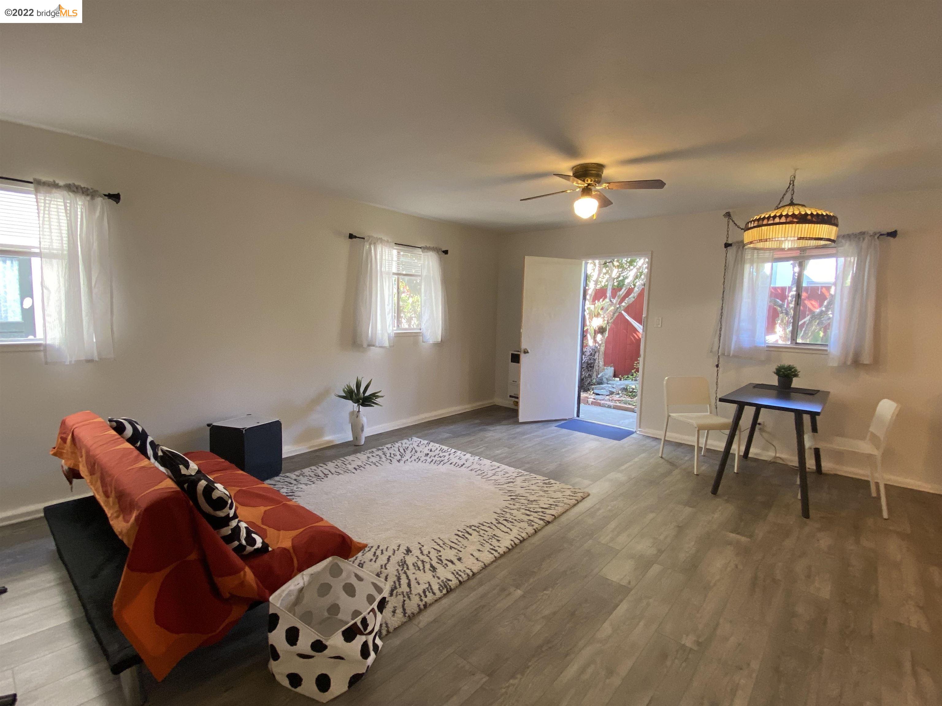 5357 Bryant Avenue Oakland, CA 94618 - Photo 4 of 26 a bedroom with furniture and a chandelier