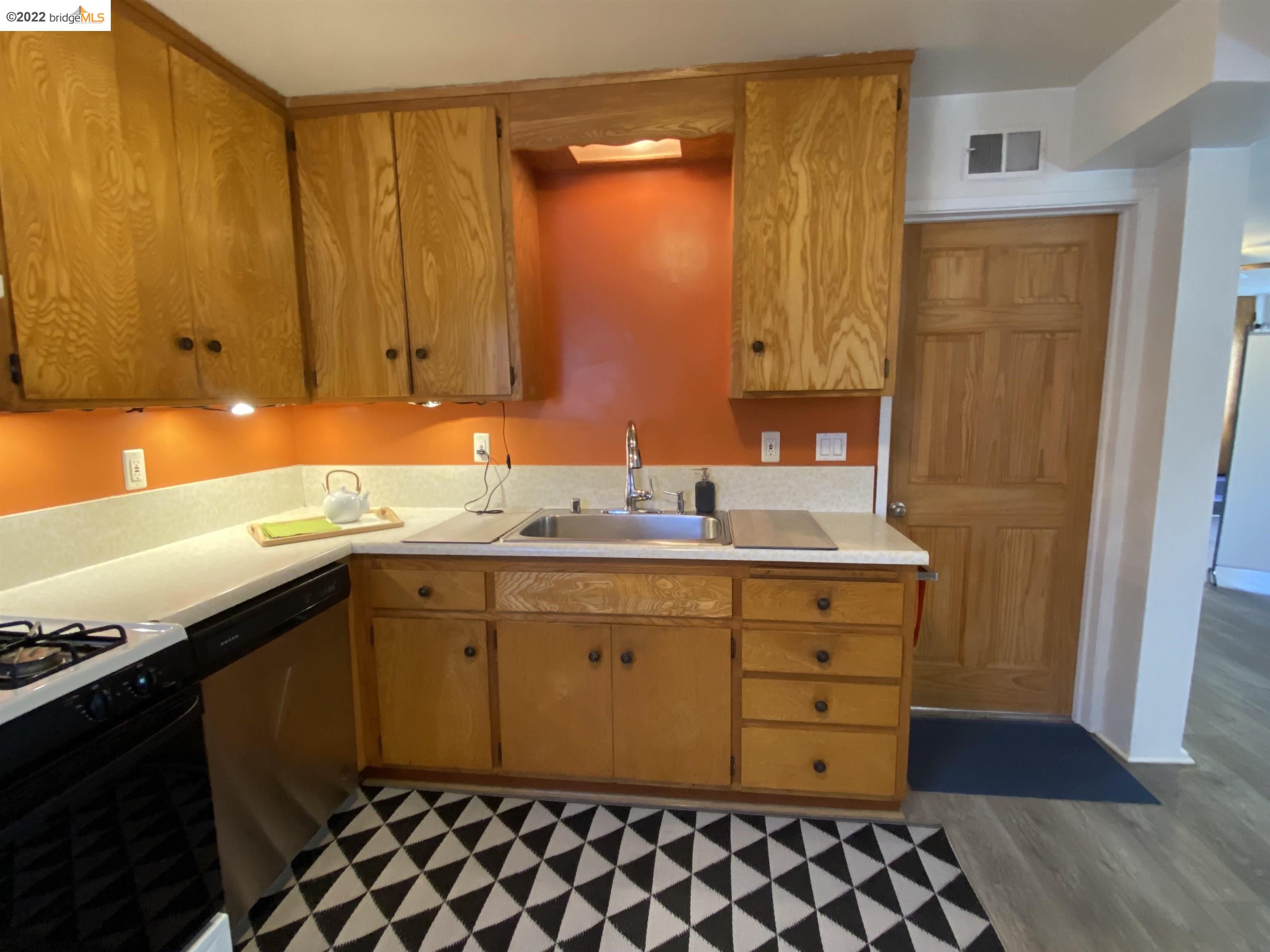 5357 Bryant Avenue Oakland, CA 94618 - Photo 7 of 26 a bathroom with a sink and a mirror
