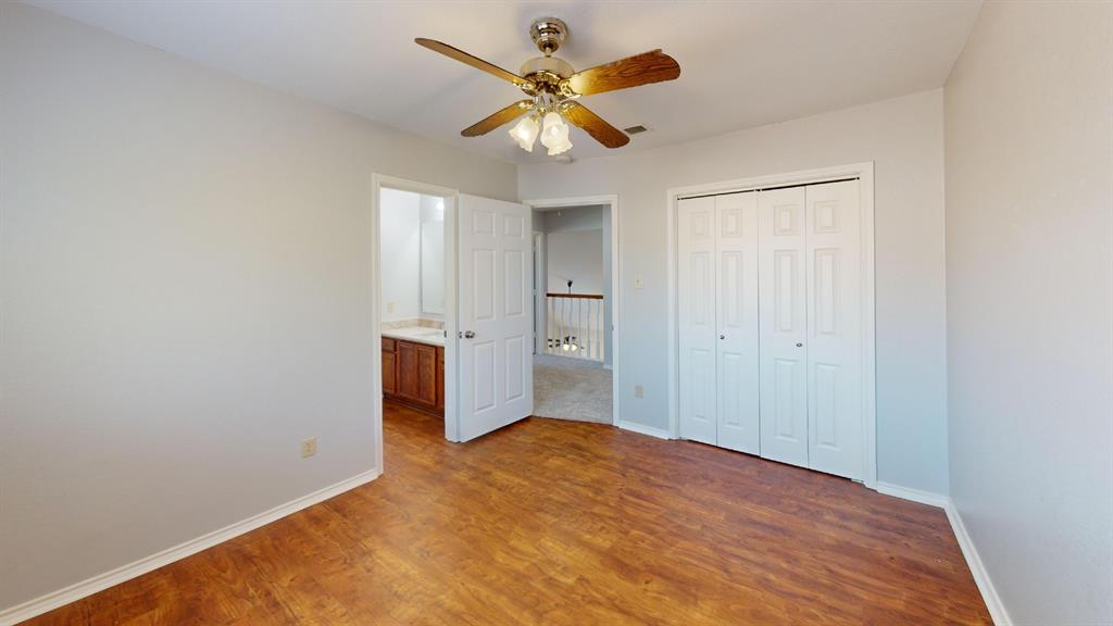 7913 Rice Drive Rowlett, TX 75088 - Photo 14 of 25 Bedroom featuring wood-finish flooring, a ceiling fan with light fixture, and bifold closet doors