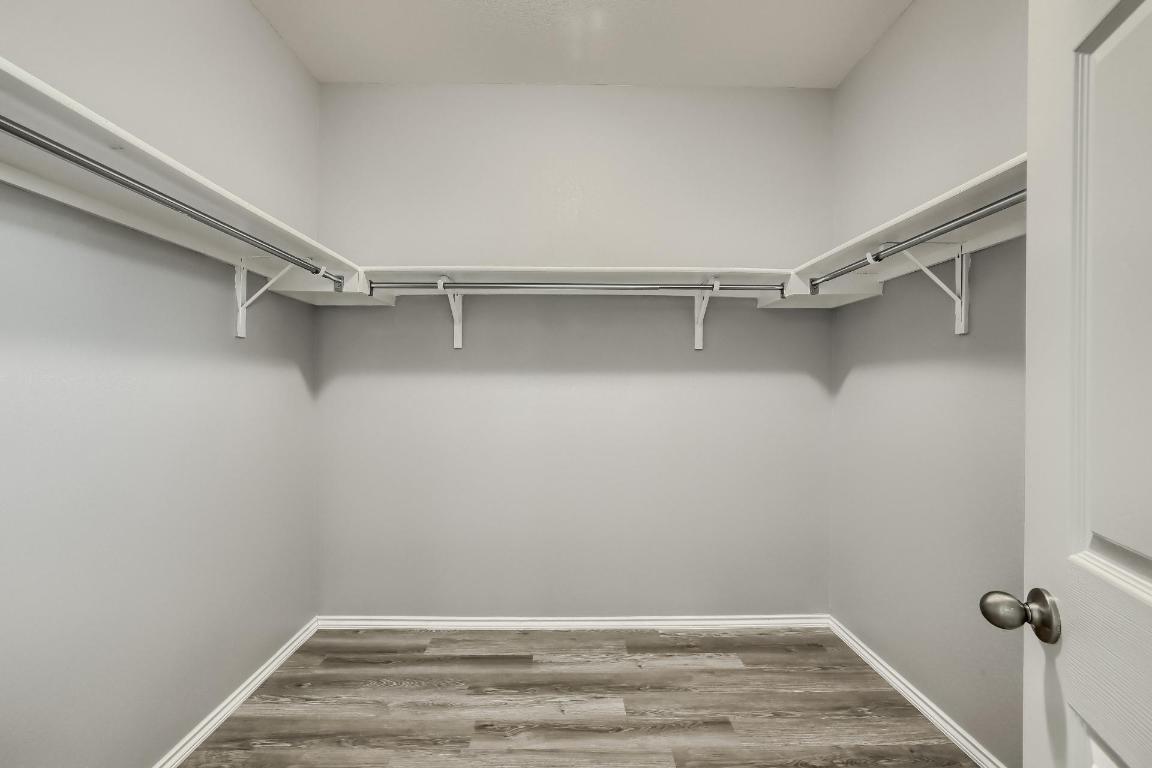 7308 Altidore Drive Austin, TX 78744 - Photo 15 of 24 Spacious closet with dark wood finished floors