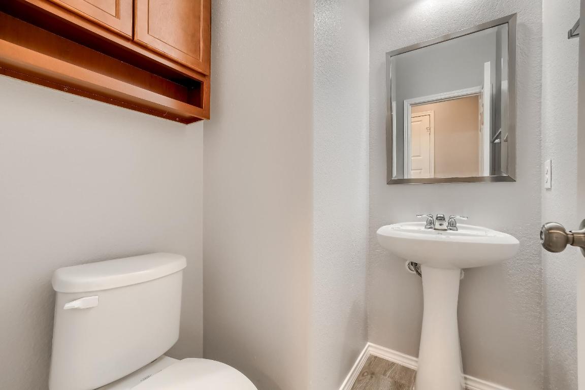 7308 Altidore Drive Austin, TX 78744 - Photo 21 of 24 Half bathroom featuring baseboards and a textured wall