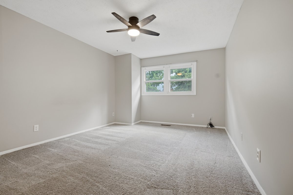 1532 Hunt Drive, Unit A Normal, IL 61761 - Photo 20 of 25 an empty room with a window and a fan