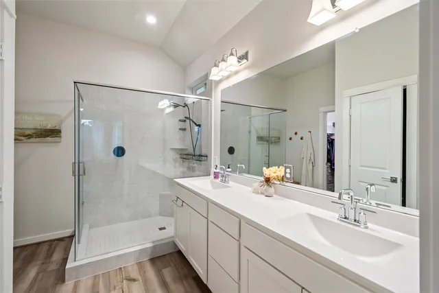 a bathroom with a sink vanity mirror and toilet