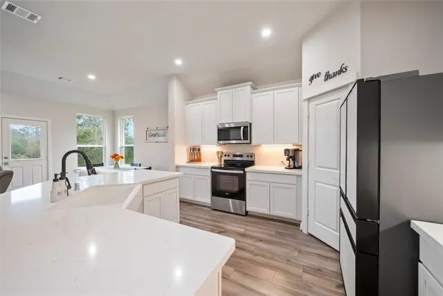 a kitchen with a sink stove and microwave