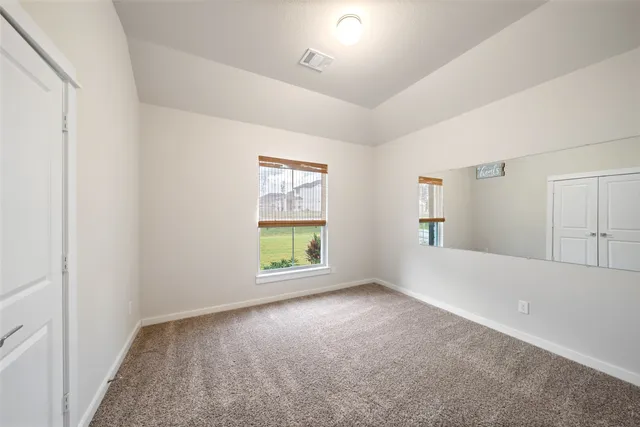 a living room with furniture windows and wooden floor