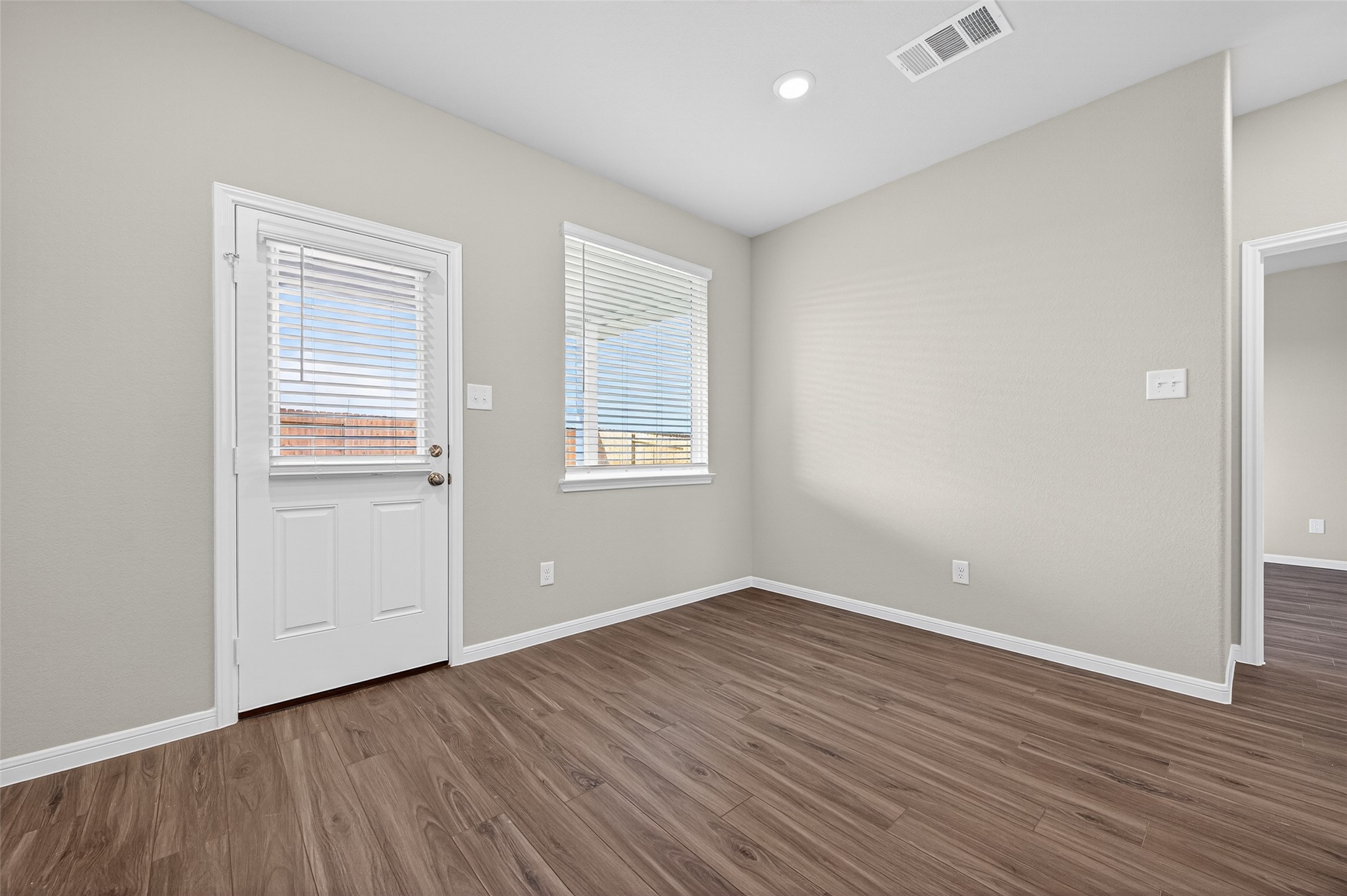 9259 Grace Rdg Drive Willis, TX 77318 - Photo 12 of 39 a view of an empty room with wooden floor and a window