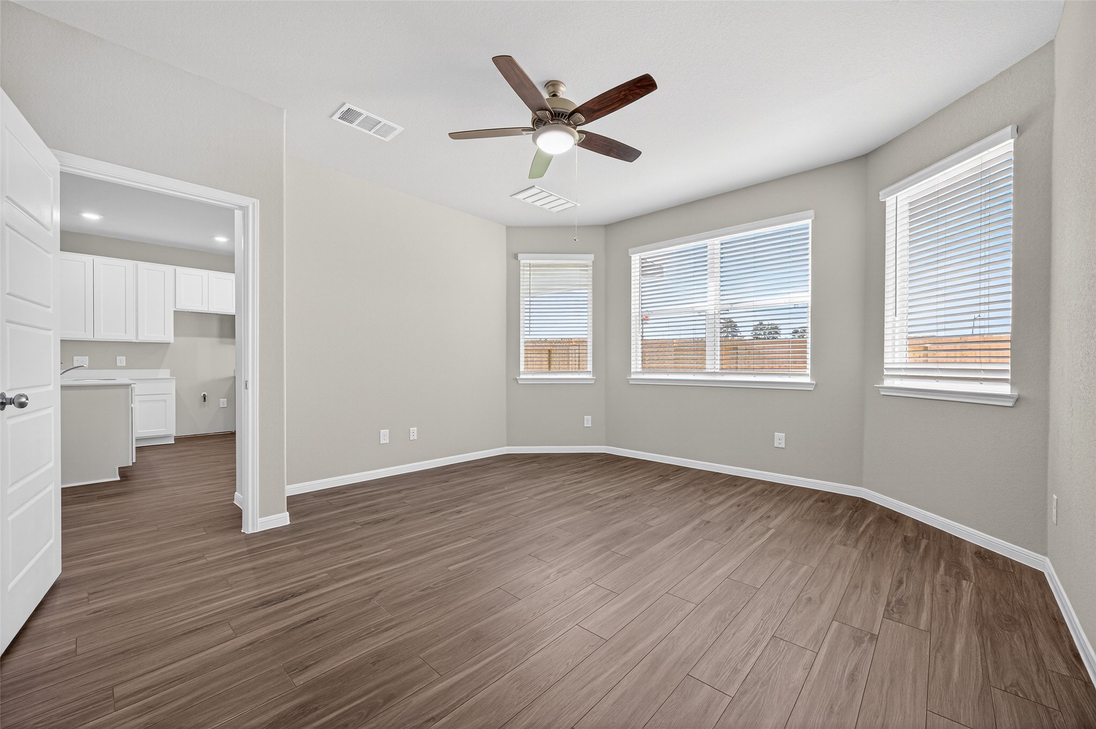 9259 Grace Rdg Drive Willis, TX 77318 - Photo 14 of 39 a view of an empty room with wooden floor and a window
