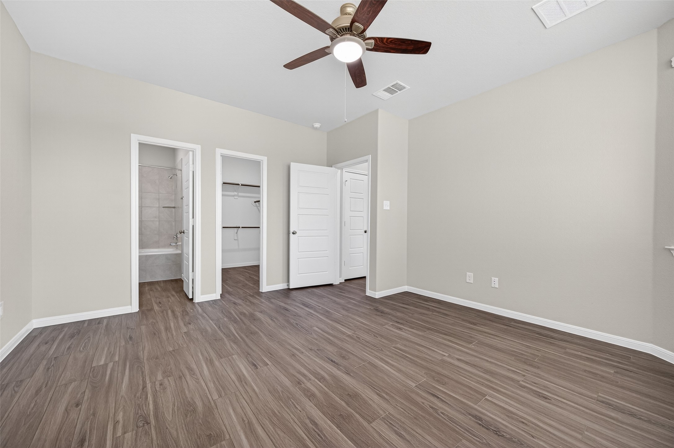 9259 Grace Rdg Drive Willis, TX 77318 - Photo 15 of 39 an empty room with wooden floor closet ceiling fan and windows