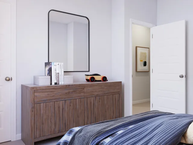 a bedroom with a bed a painting on the wall and a lamp