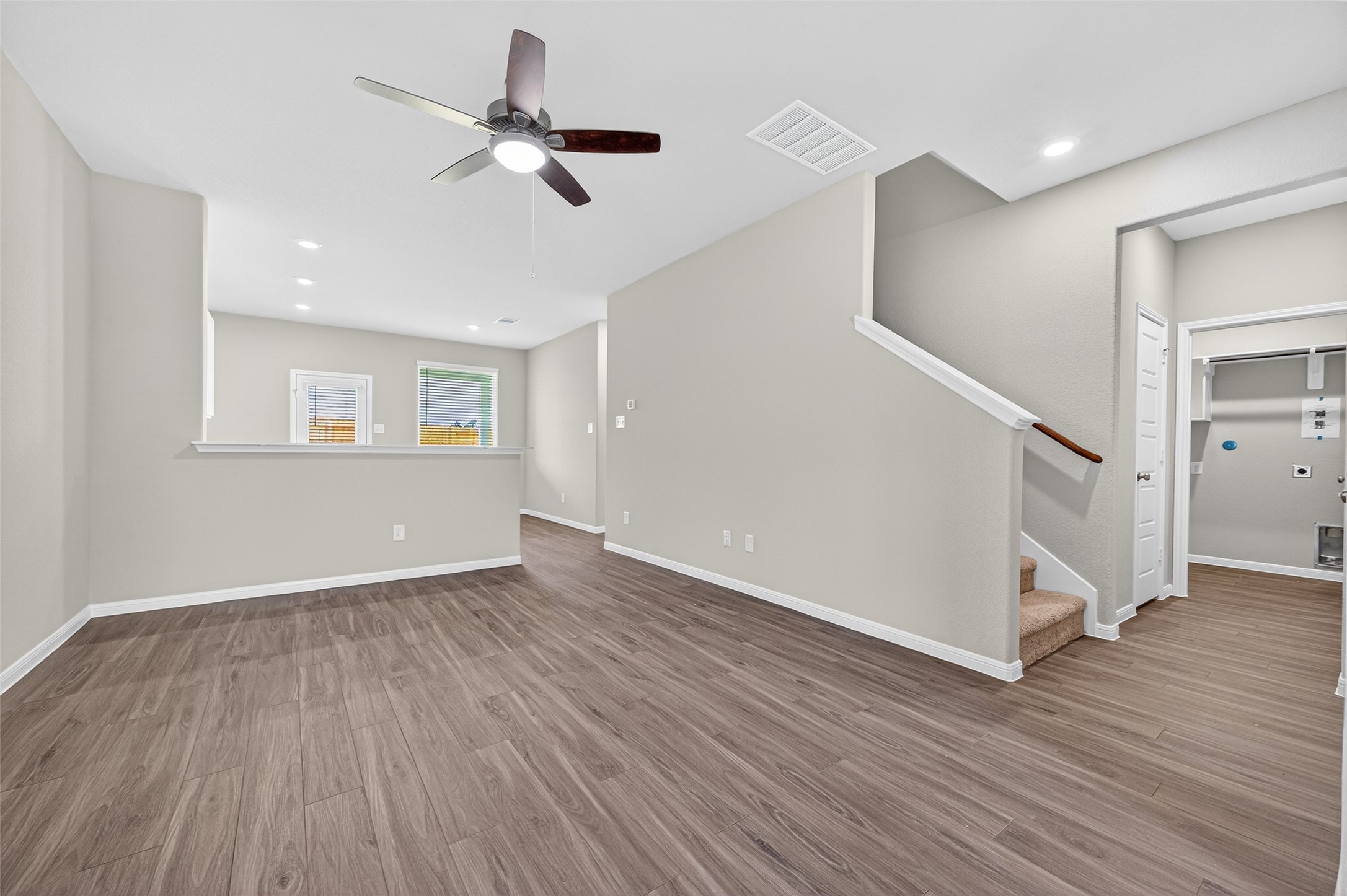 9259 Grace Rdg Drive Willis, TX 77318 - Photo 4 of 39 a view of an empty room with wooden floor and a ceiling fan