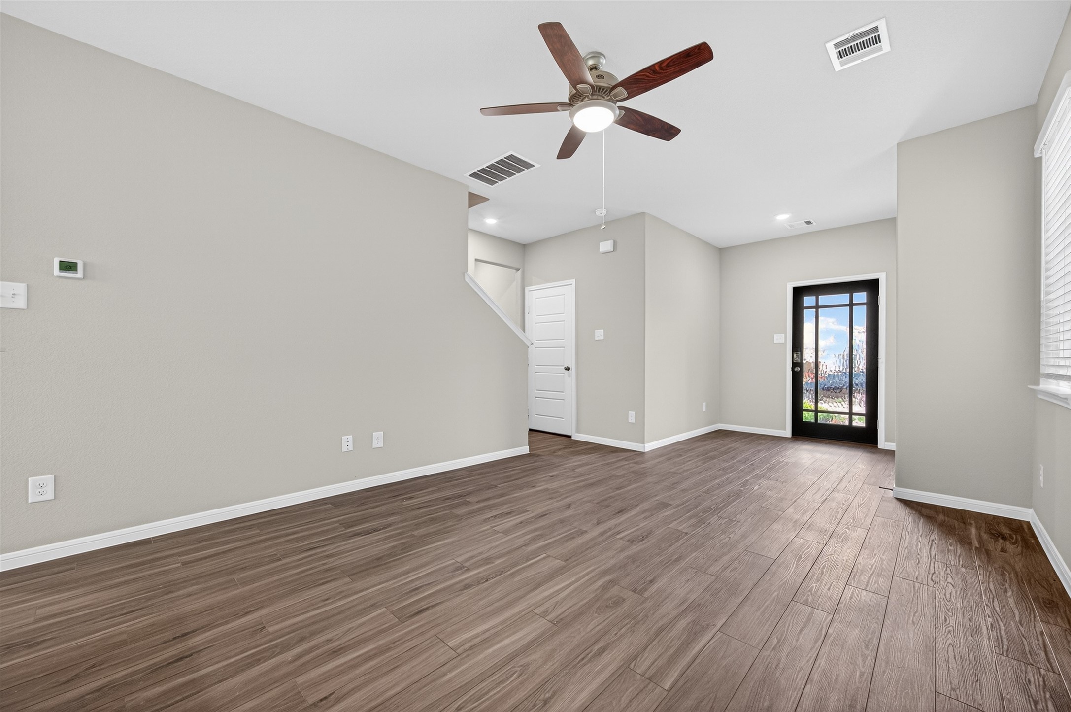 9259 Grace Rdg Drive Willis, TX 77318 - Photo 7 of 39 an empty room with wooden floor and ceiling fan