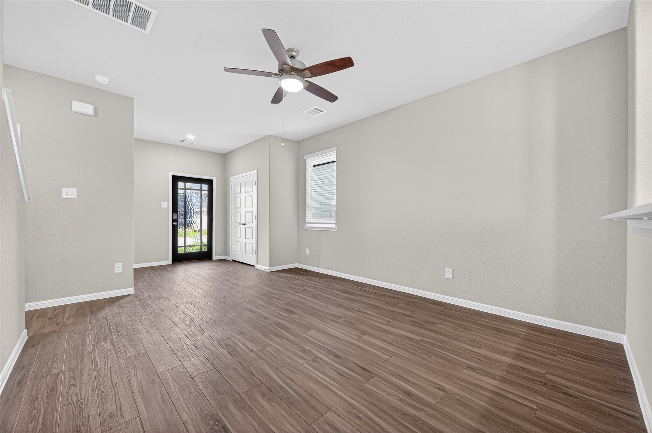 9259 Grace Rdg Drive Willis, TX 77318 - Photo 8 of 39 an empty room with wooden floor fan and windows
