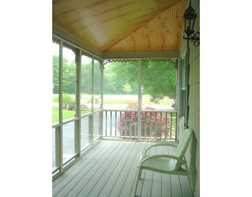 332 Bolton Road Lancaster, MA 01523 - Photo 3 of 13 a living room with a floor to ceiling window and wooden floor