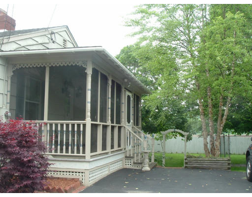 332 Bolton Road Lancaster, MA 01523 - Photo 4 of 13 a view of a house with a small yard and wooden fence