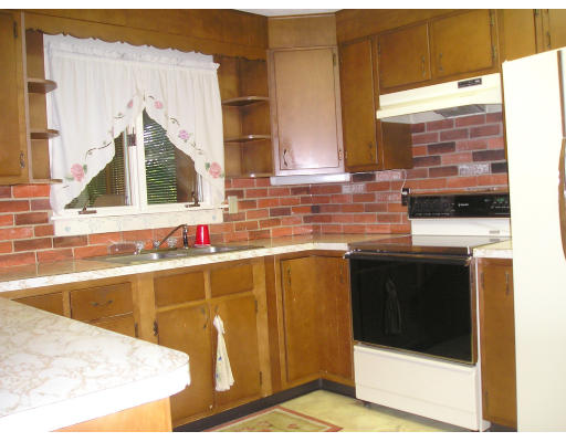 332 Bolton Road Lancaster, MA 01523 - Photo 6 of 13 a kitchen with a sink stove and cabinets
