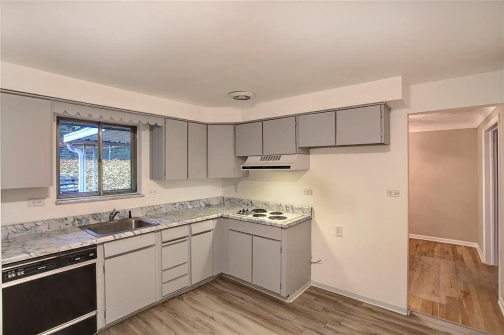 112 Washington Road Forest Hills, PA 15221 - Photo 12 of 24 Kitchen with Front of Window Sink, New Laminate Flooring, Newly Painted