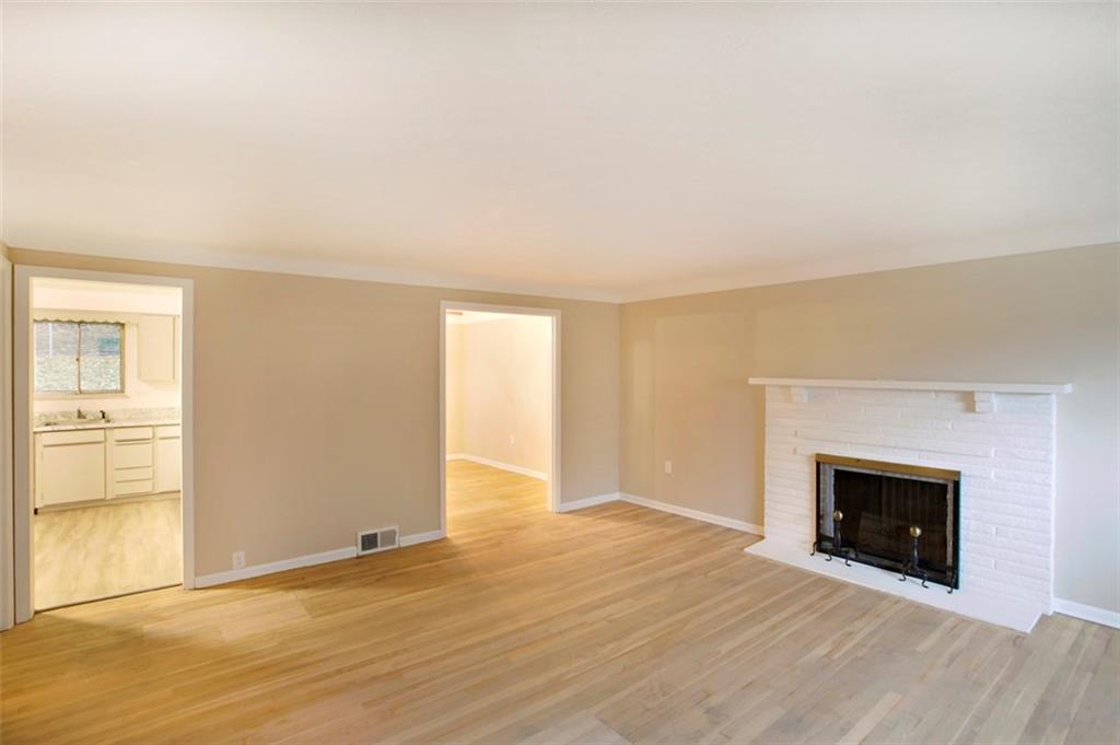 112 Washington Road Forest Hills, PA 15221 - Photo 9 of 24 18x11 Living Room with Beautiful Brick Fireplace with Access to Eat-in Kitchen and Dining Room