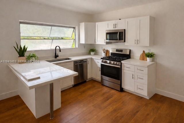 a kitchen with a stove a sink and a microwave