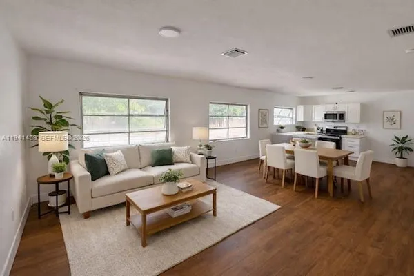 a living room with furniture and a large window