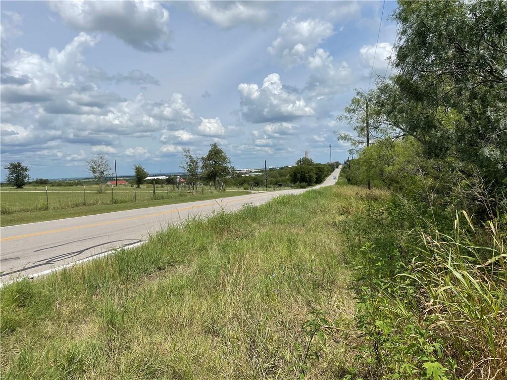 9025 Burklund Farms Road Del Valle, TX 78617 - Photo 5 of 14 a view of a yard and an ocean view
