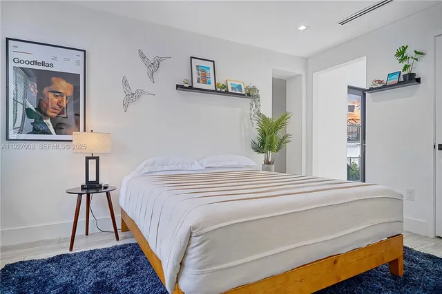 a bedroom with a bed and a painting on the wall