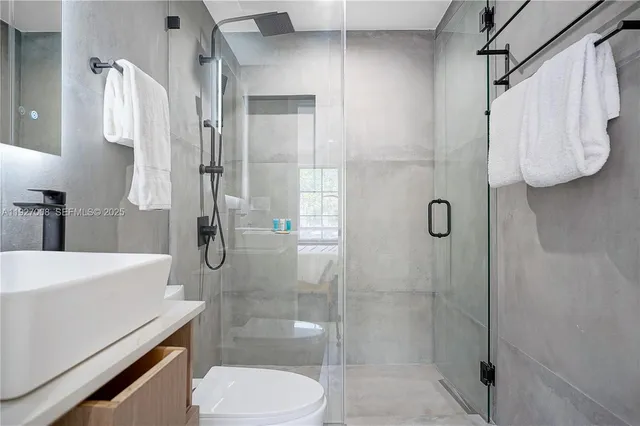 a bathroom with a shower and toilet