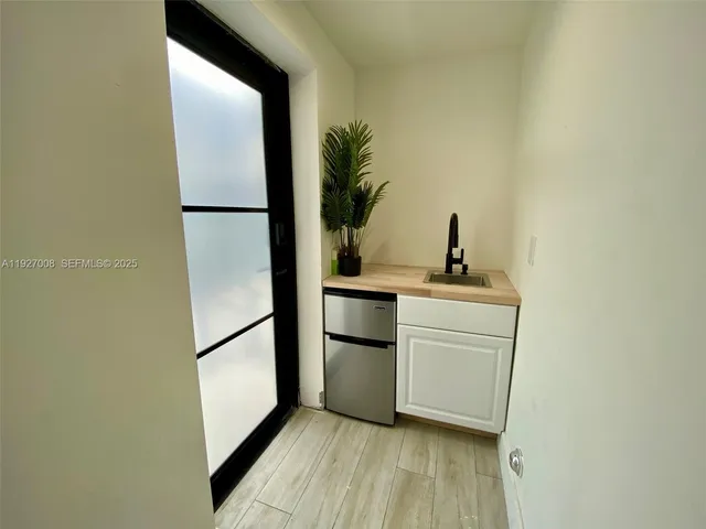 a kitchen with a refrigerator and a sink