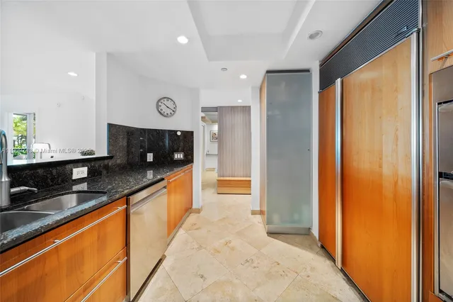 a kitchen with stainless steel appliances granite countertop a sink and a stove