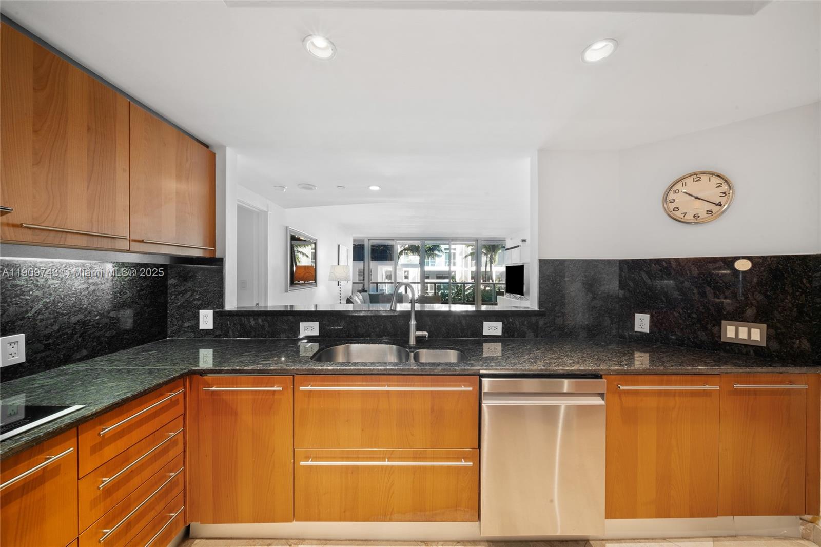 9401 Collins Avenue, Unit 205 Surfside, FL 33154 - Photo 12 of 36 a kitchen with stainless steel appliances granite countertop a sink and a stove