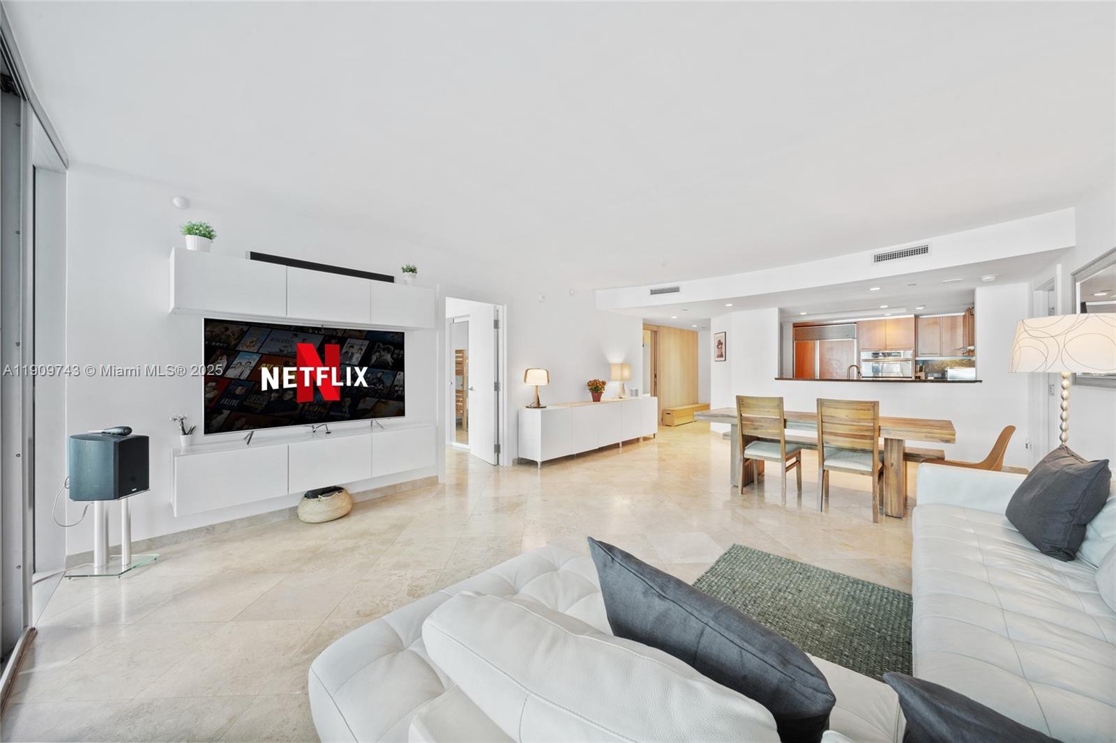 9401 Collins Avenue, Unit 205 Surfside, FL 33154 - Photo 16 of 36 a living room with furniture and a flat screen tv