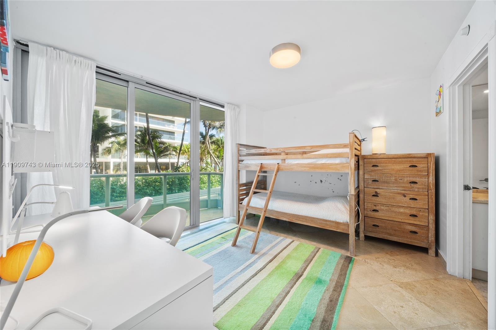 9401 Collins Avenue, Unit 205 Surfside, FL 33154 - Photo 17 of 36 a bedroom with a bed and a lamp