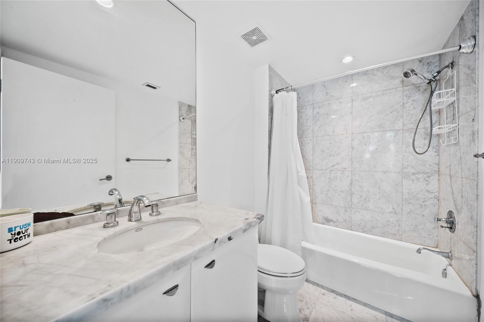 9401 Collins Avenue, Unit 205 Surfside, FL 33154 - Photo 18 of 36 a bathroom with a sink toilet tub and shower
